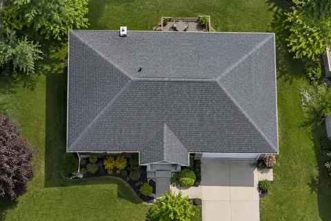 Asphalt shingle roof edge with fascia and gutter.